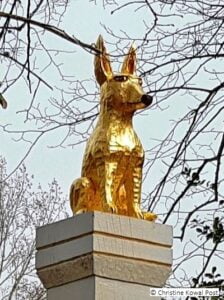 Gold dog sculpture by Christine Kowal Post